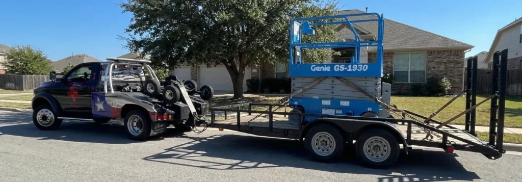 image of a Genie Gs-1930 Scissors lift being towed by Texas Patriot Towing